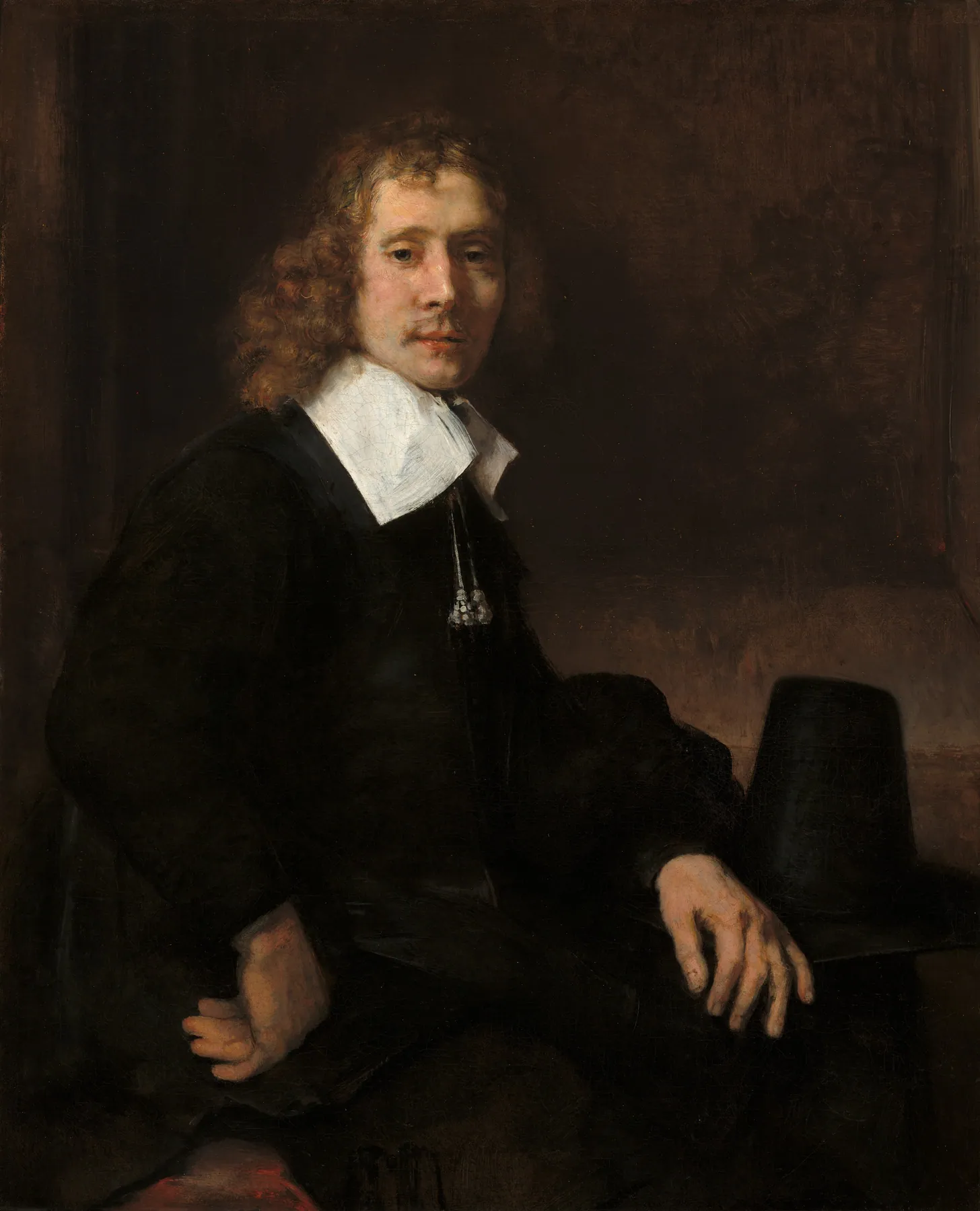 Joven sentado a una mesa (posiblemente Govaert Flinck), de Rembrandt van Rijn